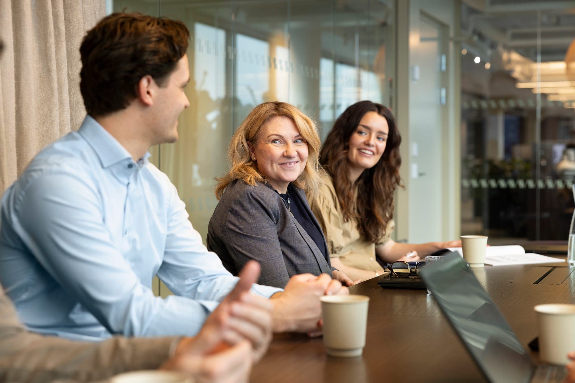 Allshares colleagues in conversation around a meeting table